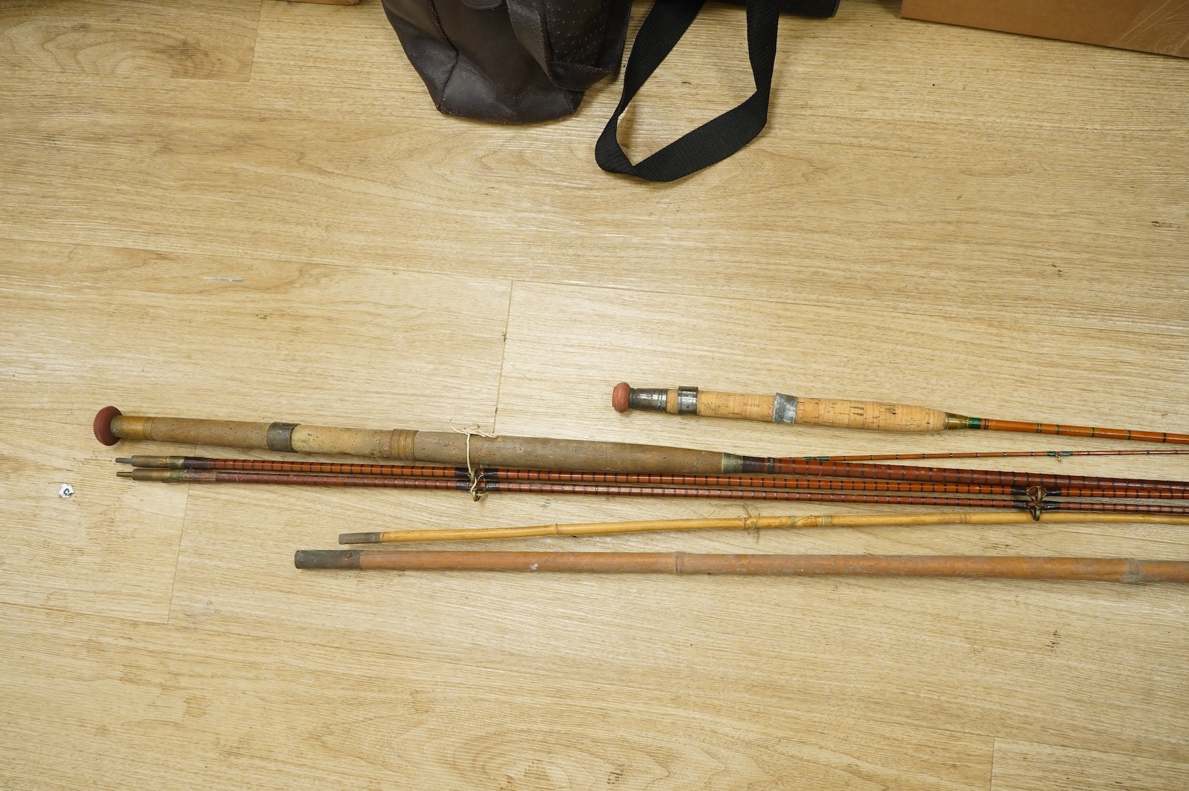 A collection of split cane fishing rods, reels, landing net etc contained in a large wooden box